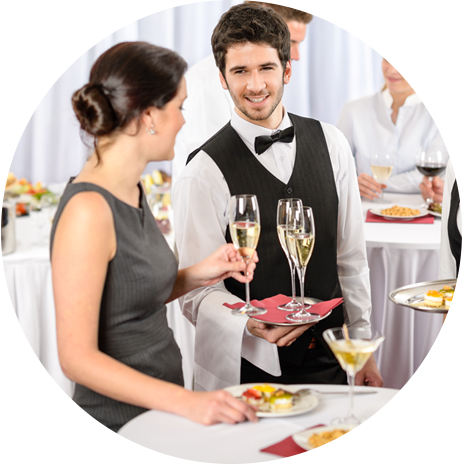 Waiter serving drink to a lady